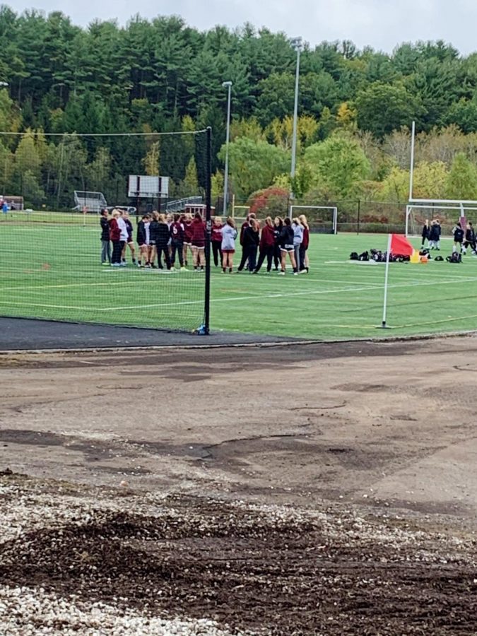 Portsmouth receiving a pep talk from coaches, Brint Shone and Hanna Strong, pre game