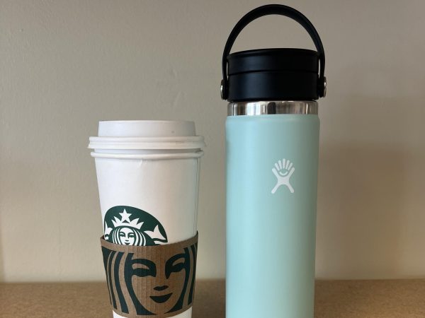 A Starbucks cup, next to a reusable cup
