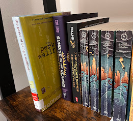 "Perks of Being a Wallflower" on a bookshelf, surrounded by other popular books.