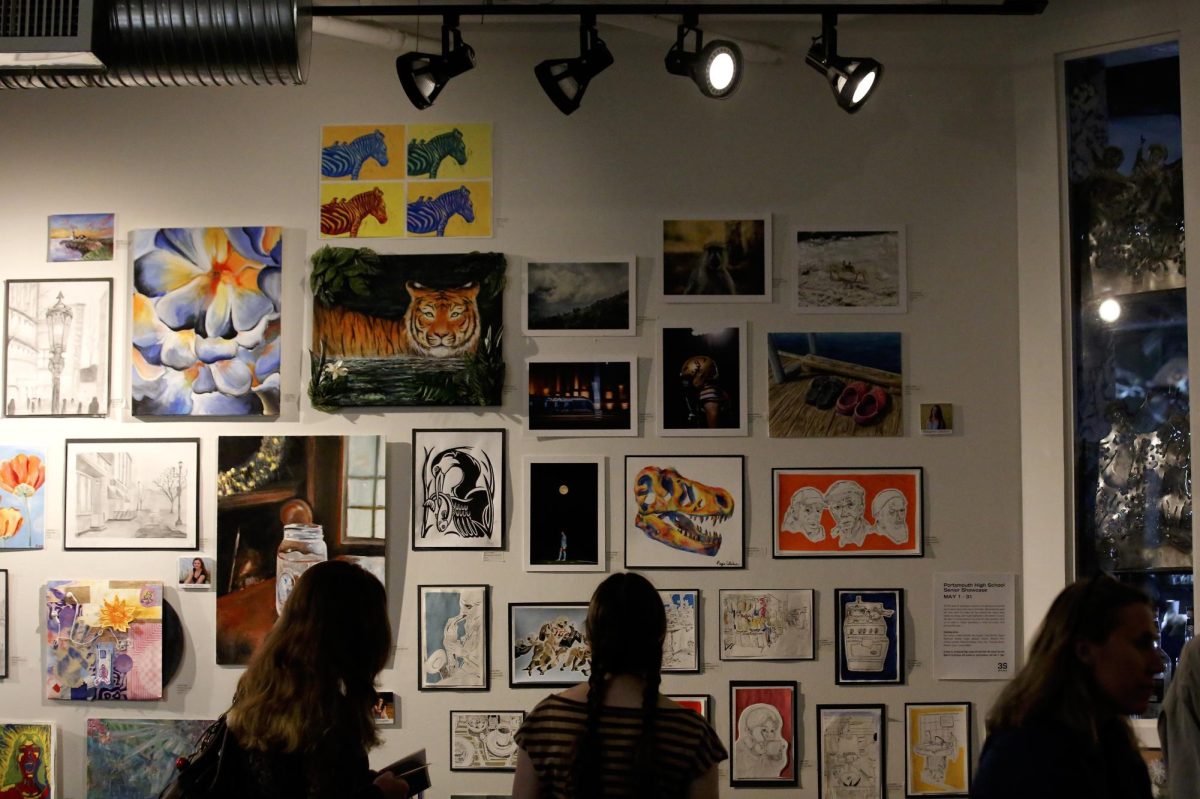 People look at the seniors display during the Fine Arts Night in Portsmouth, N.H., Friday, May 22, 2026.